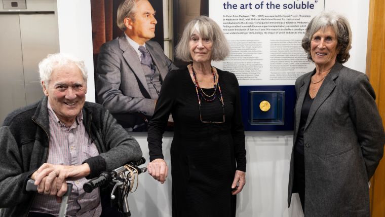 Peter Medawar's children stand in front of the medal display case